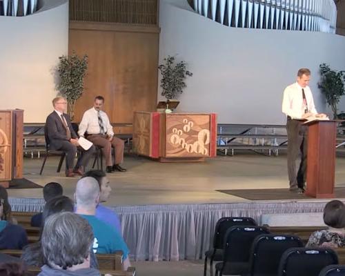 Theology professor speaking at a podium