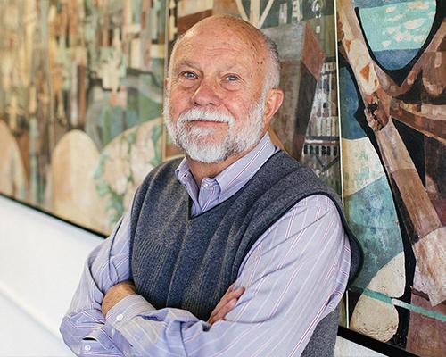 Gerald Brommer standing in front of his mural