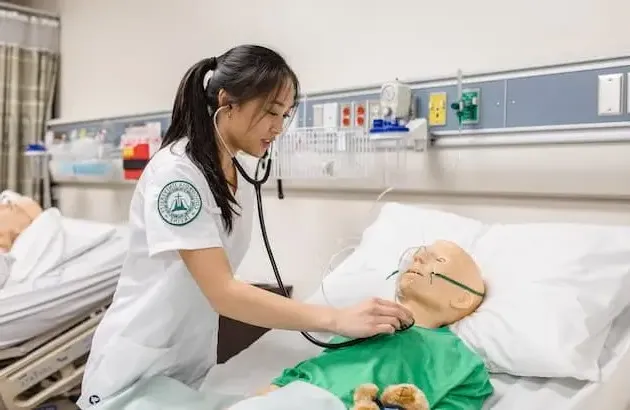 Nursing student practicing on dummy